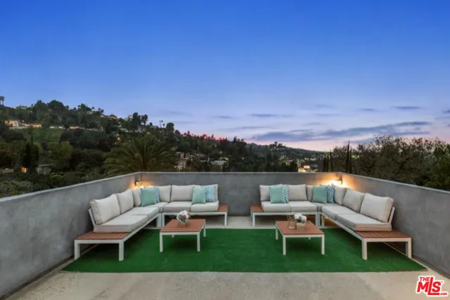 a view of a patio with couches and a table and chairs