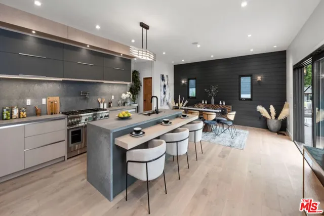 a kitchen with a sink stainless steel appliances and cabinets