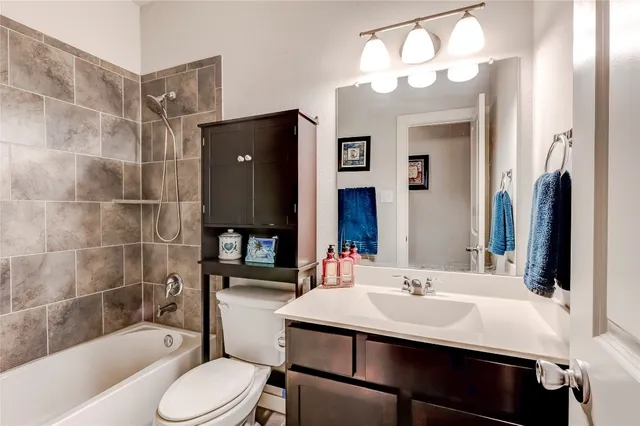 a bedroom with a bed and a flat tv screen on a dresser
