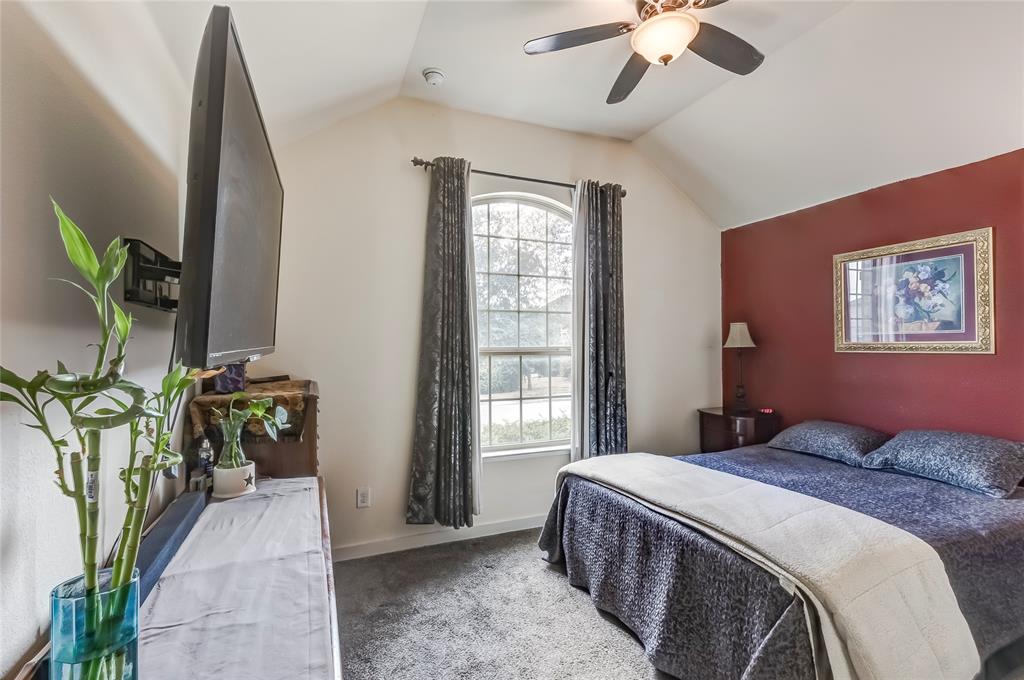 231 Windswept Way Kyle, TX 78640 - Photo 22 of 33 a spacious bedroom with a balcony a bed and a chandelier