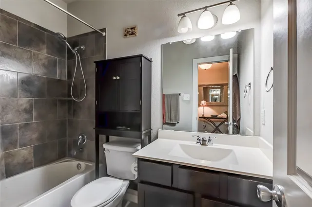 a spacious bedroom with a balcony a bed and a chandelier