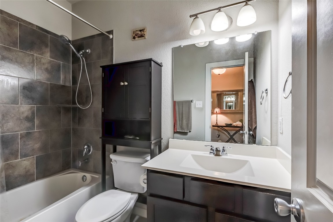 231 Windswept Way Kyle, TX 78640 - Photo 22 of 39 a bathroom with a sink a toilet a mirror and shower