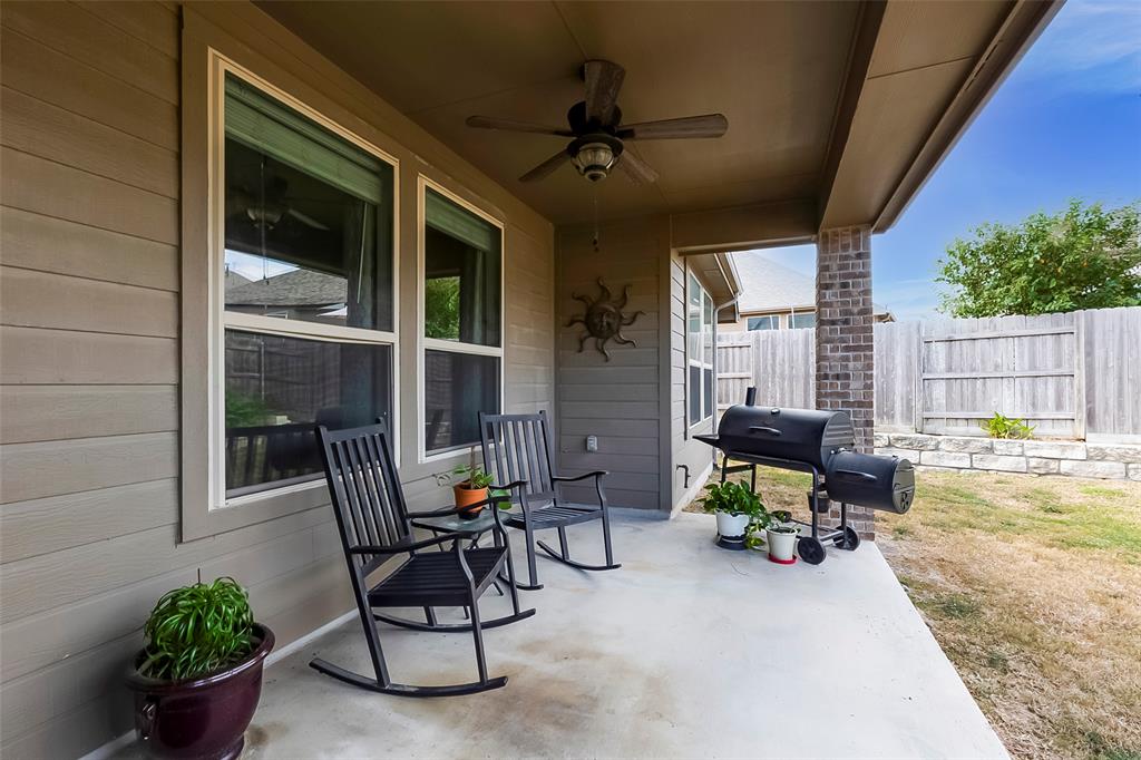 231 Windswept Way Kyle, TX 78640 - Photo 25 of 33 a view of a porch with chairs and potted plants with wooden fence