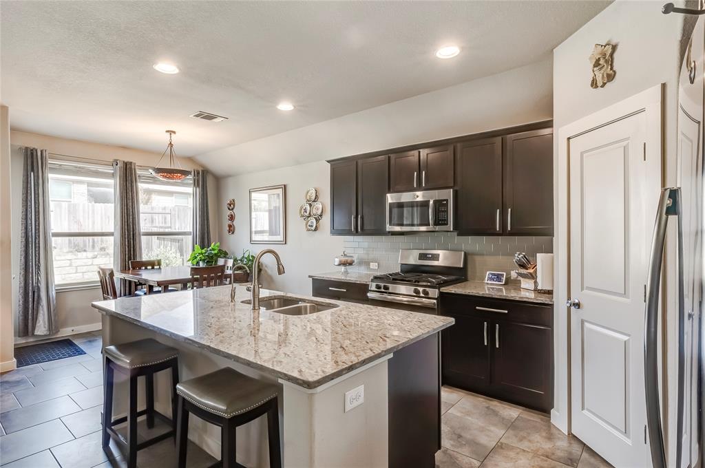 231 Windswept Way Kyle, TX 78640 - Photo 4 of 33 a kitchen with granite countertop a sink appliances and cabinets