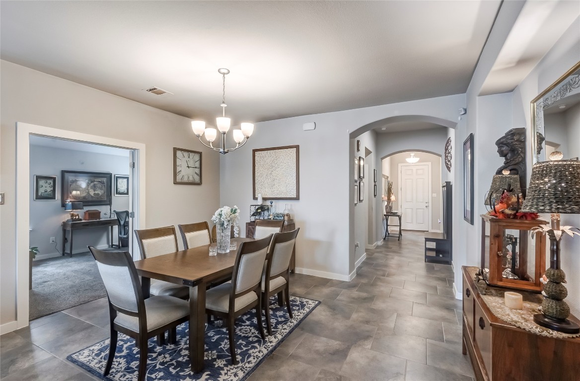 231 Windswept Way Kyle, TX 78640 - Photo 8 of 39 a view of a dining room with furniture and chandelier