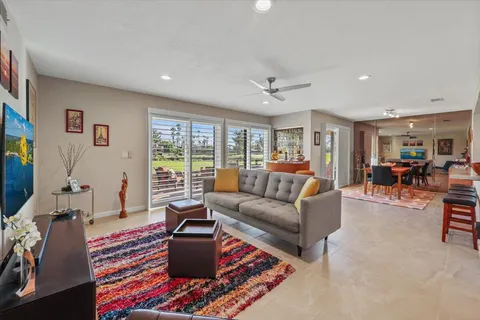 a living room with furniture fireplace and a window