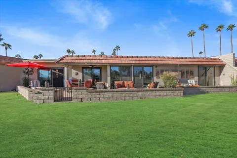 a view of a patio with table and chairs potted plants with wooden floor