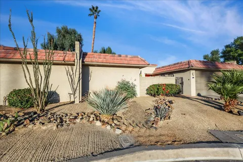 a view of a patio with a table and chairs and potted plants