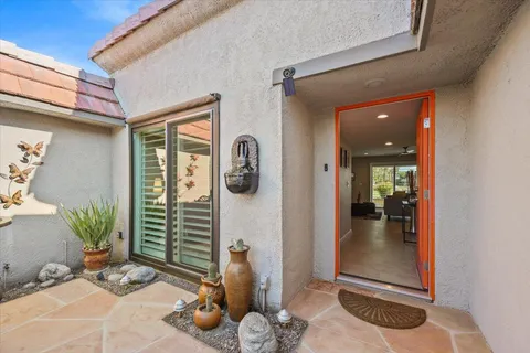 a dining hall with stainless steel appliances kitchen island granite countertop a dining table and chairs with wooden floor