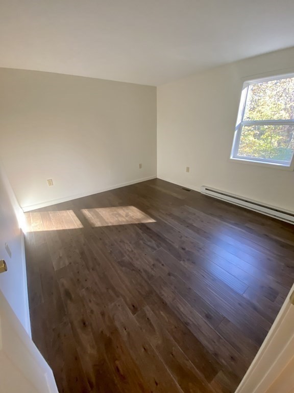 129 Greenwich Road Ware, MA 01082 - Photo 12 of 31 an empty room with wooden floor and windows