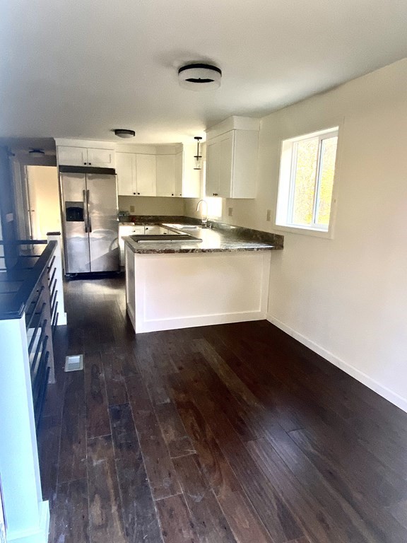 129 Greenwich Road Ware, MA 01082 - Photo 3 of 31 a view of open kitchen with granite countertop wooden floor white cabinets and stainless steel appliances