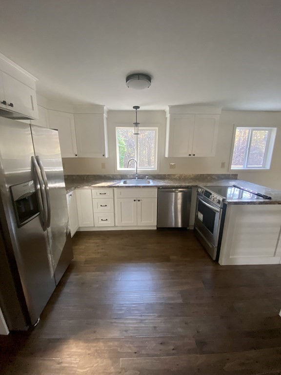 129 Greenwich Road Ware, MA 01082 - Photo 6 of 31 a kitchen with stainless steel appliances granite countertop wooden floors and white cabinets