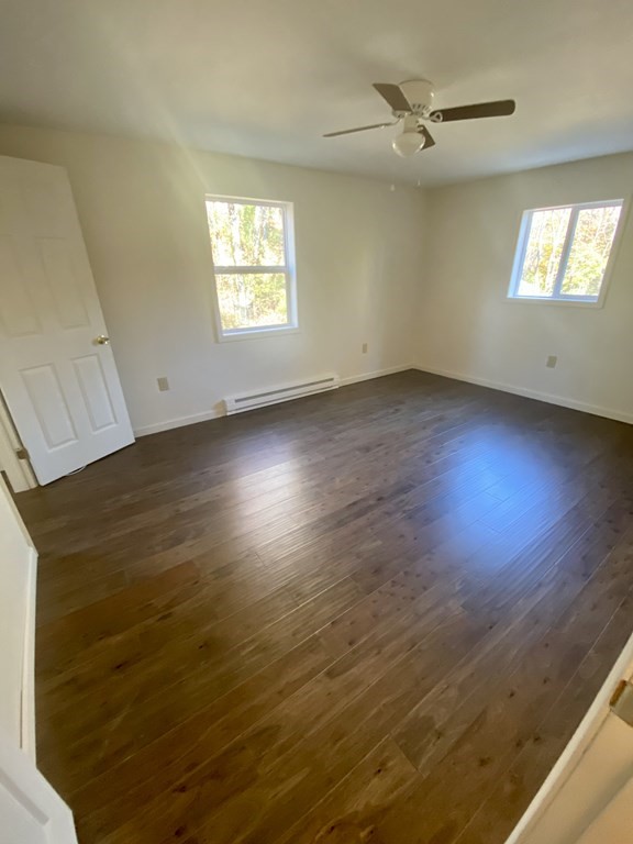 129 Greenwich Road Ware, MA 01082 - Photo 10 of 31 an empty room with wooden floor and windows