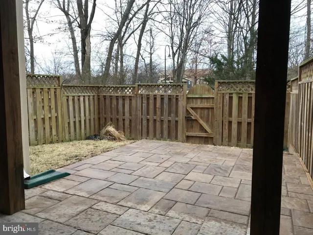 a view of wooden fence and trees around