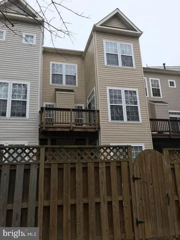 a view of a house with wooden fence