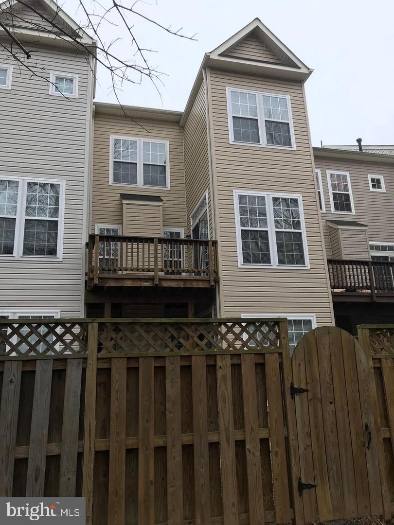 21927 Windy Oaks Square Broadlands, VA 20148 - Photo 14 of 18 a view of a house with wooden fence