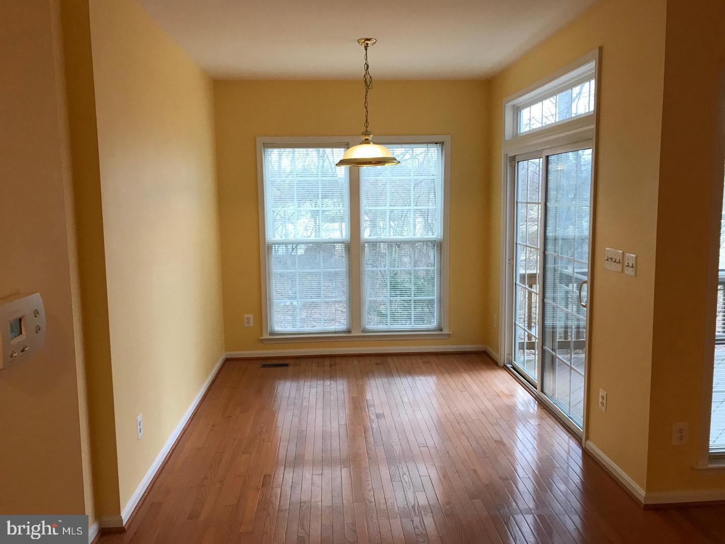 21927 Windy Oaks Square Broadlands, VA 20148 - Photo 2 of 18 a view of empty room with wooden floor and fan