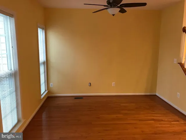 a view of a room with wooden floor and a window
