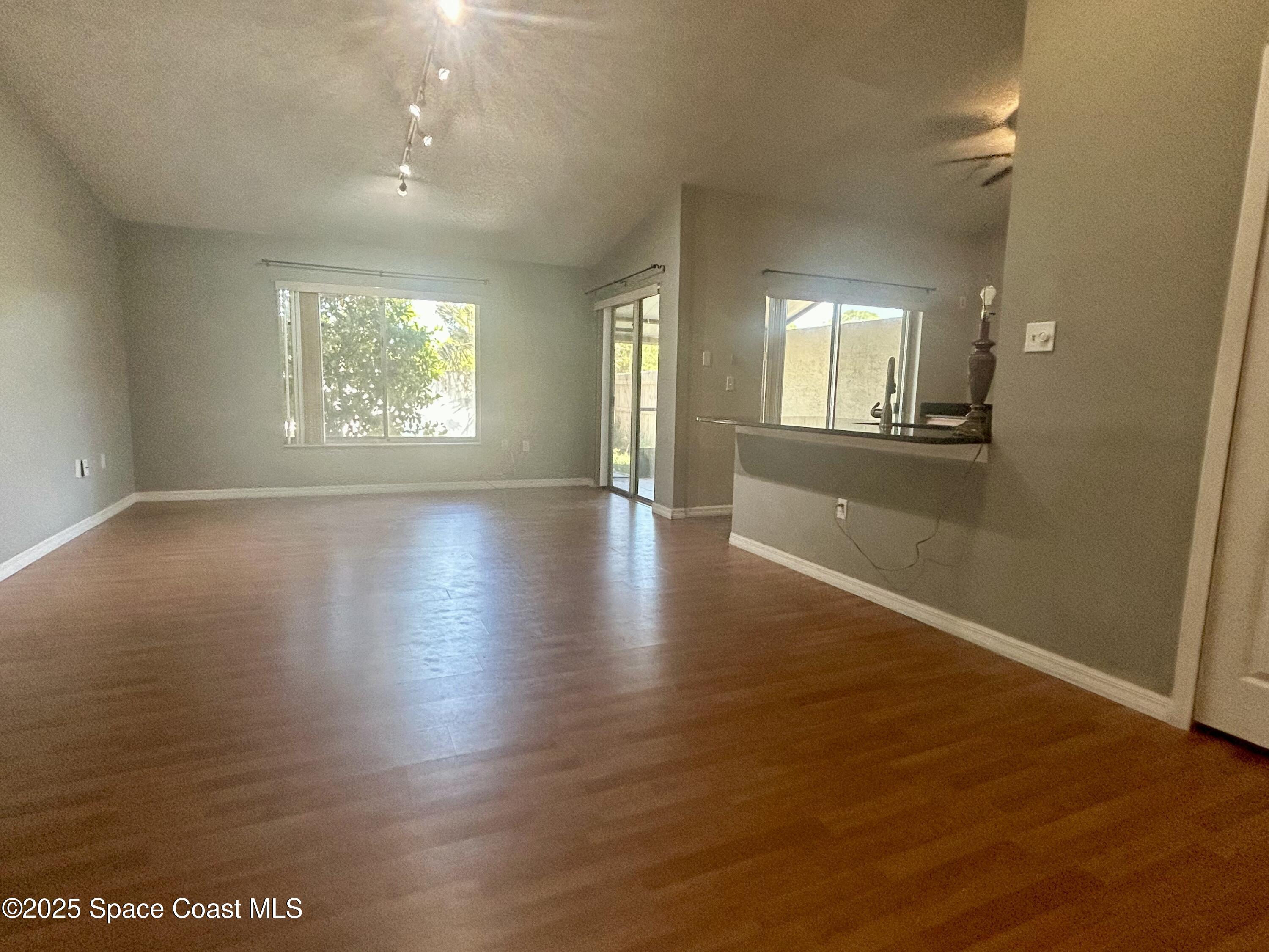 834 Barbados Avenue Melbourne, FL 32901 - Photo 1 of 12 an empty room with wooden floor and windows