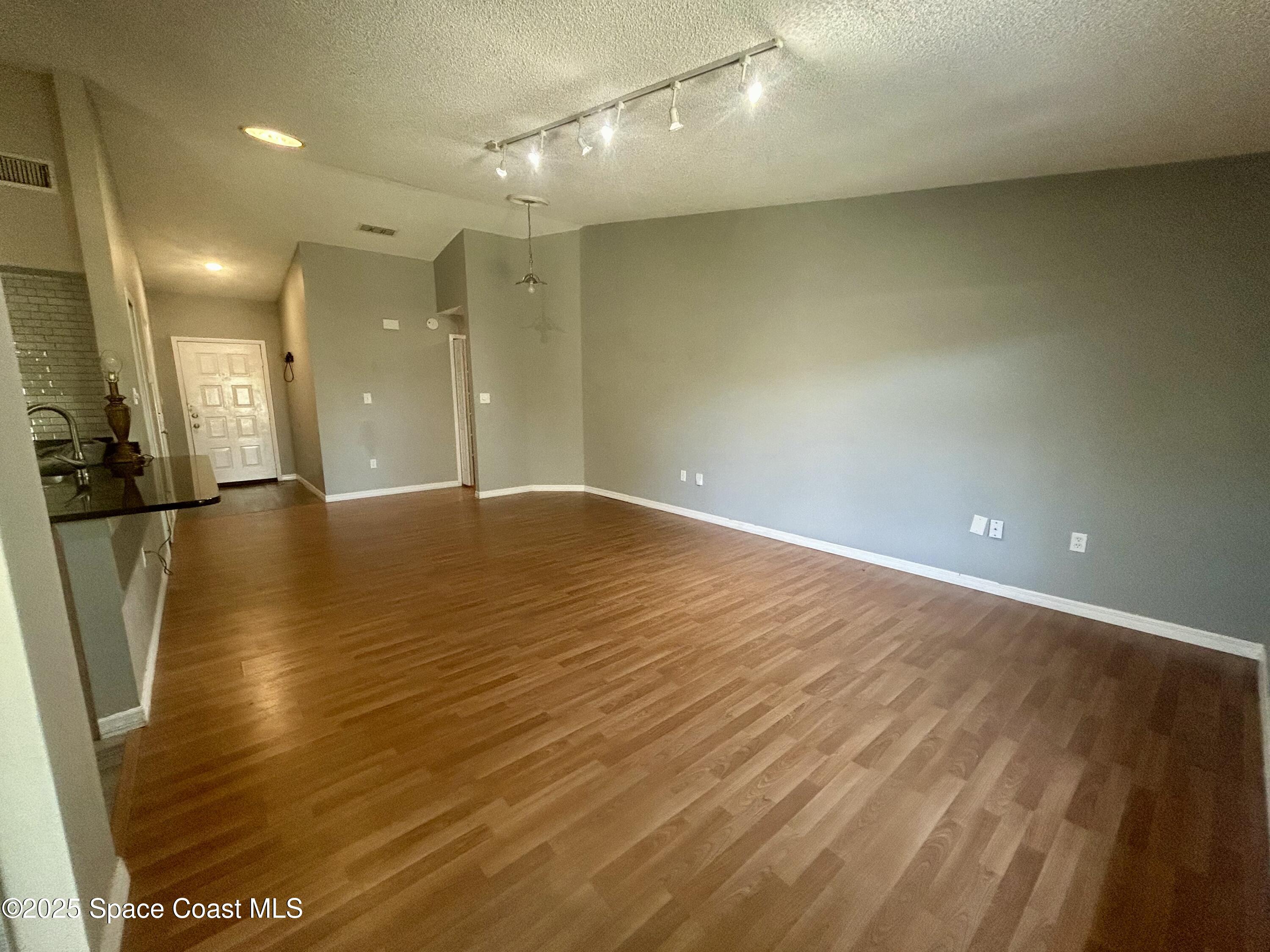834 Barbados Avenue Melbourne, FL 32901 - Photo 2 of 12 a view of an empty room with wooden floor