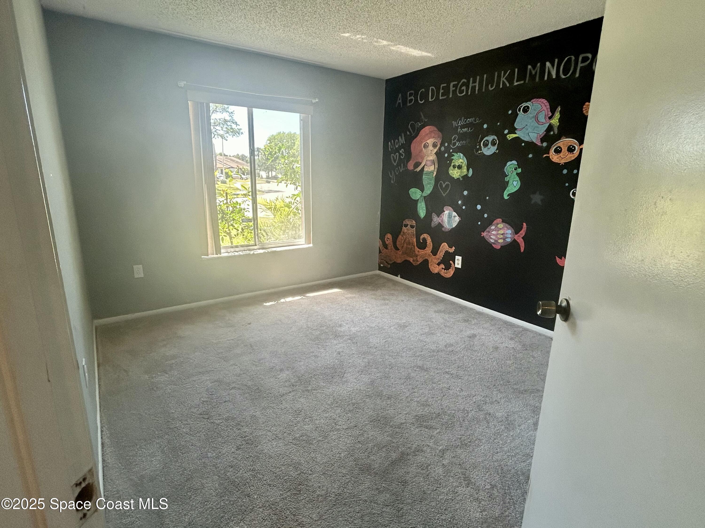 834 Barbados Avenue Melbourne, FL 32901 - Photo 4 of 12 an empty room with windows and tree