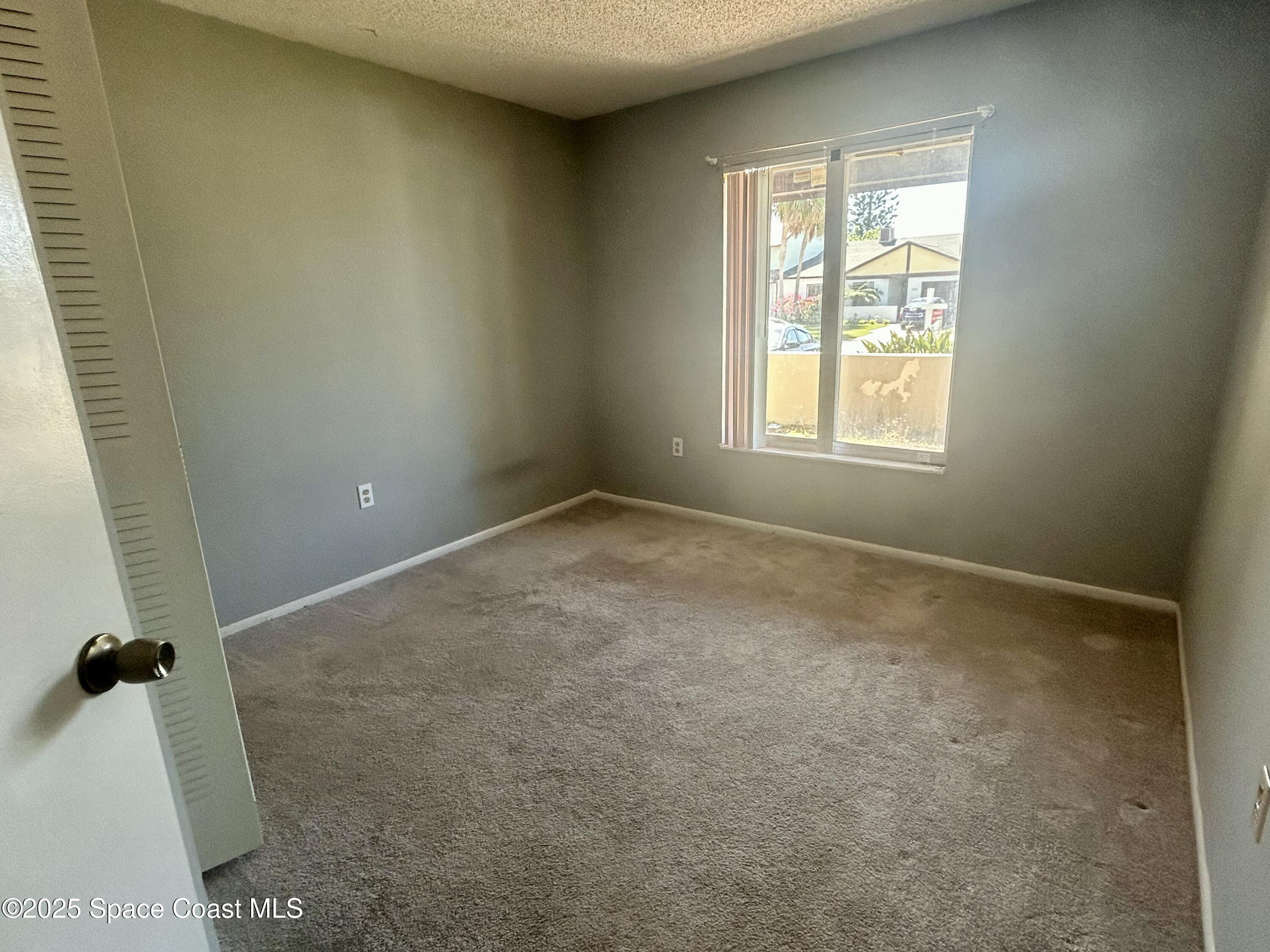 834 Barbados Avenue Melbourne, FL 32901 - Photo 6 of 12 an empty room with a window