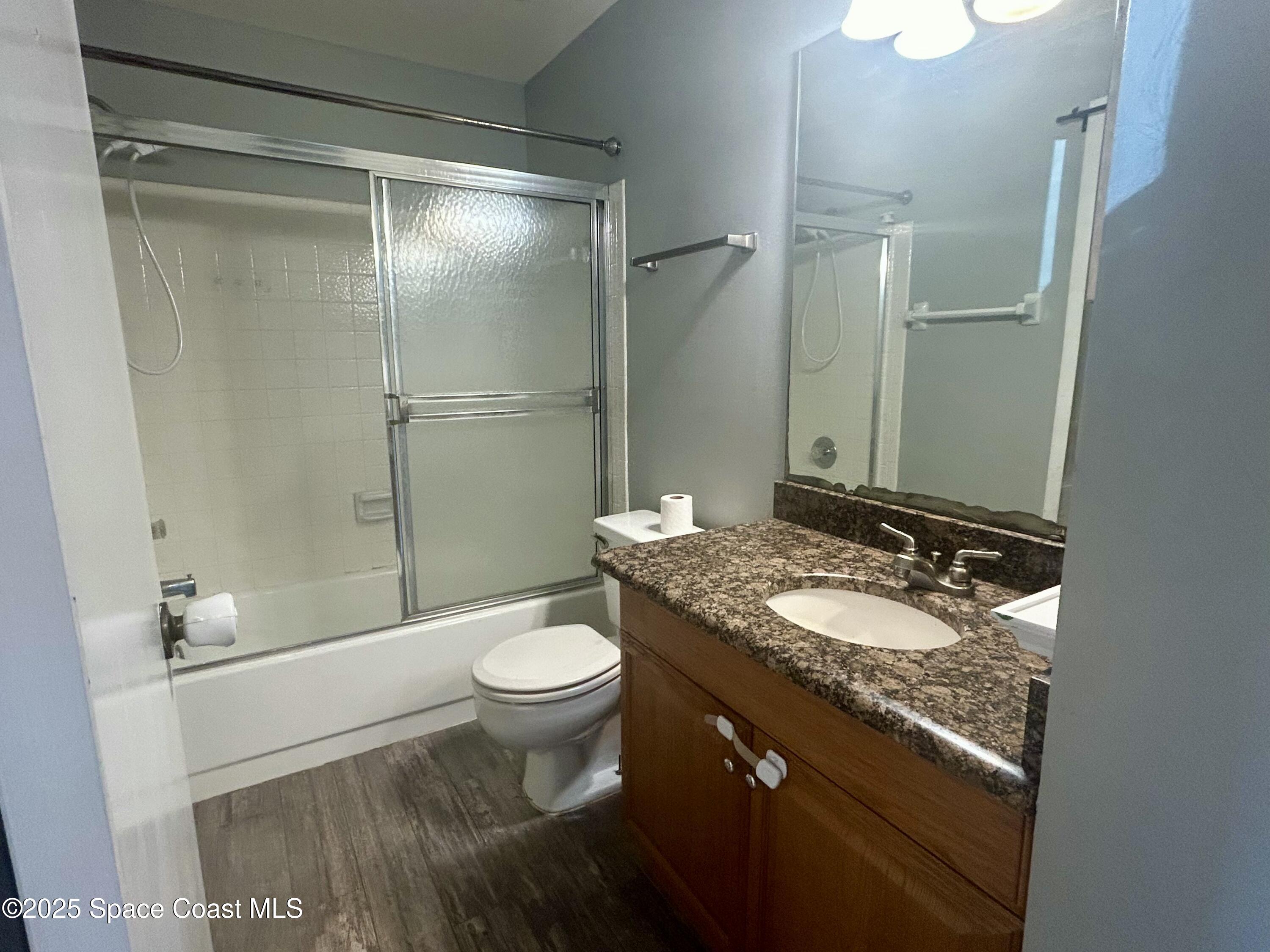 834 Barbados Avenue Melbourne, FL 32901 - Photo 8 of 12 a bathroom with a granite countertop sink toilet and shower