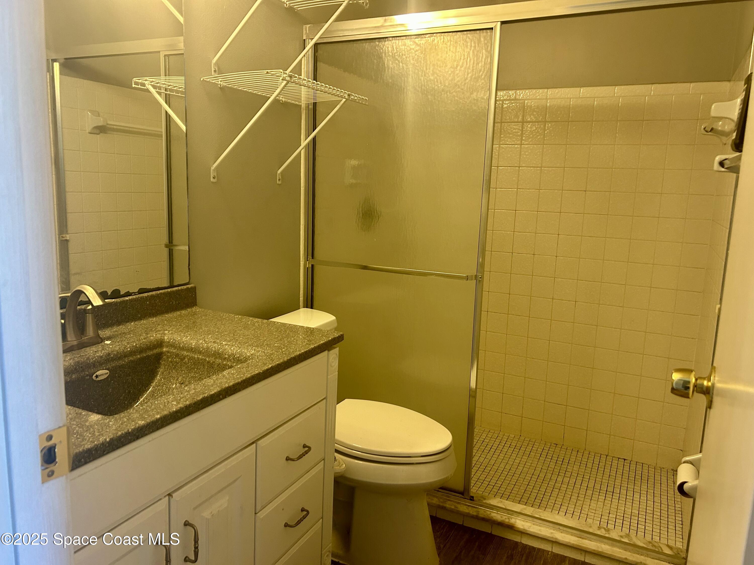 834 Barbados Avenue Melbourne, FL 32901 - Photo 9 of 12 a bathroom with a sink a toilet and shower