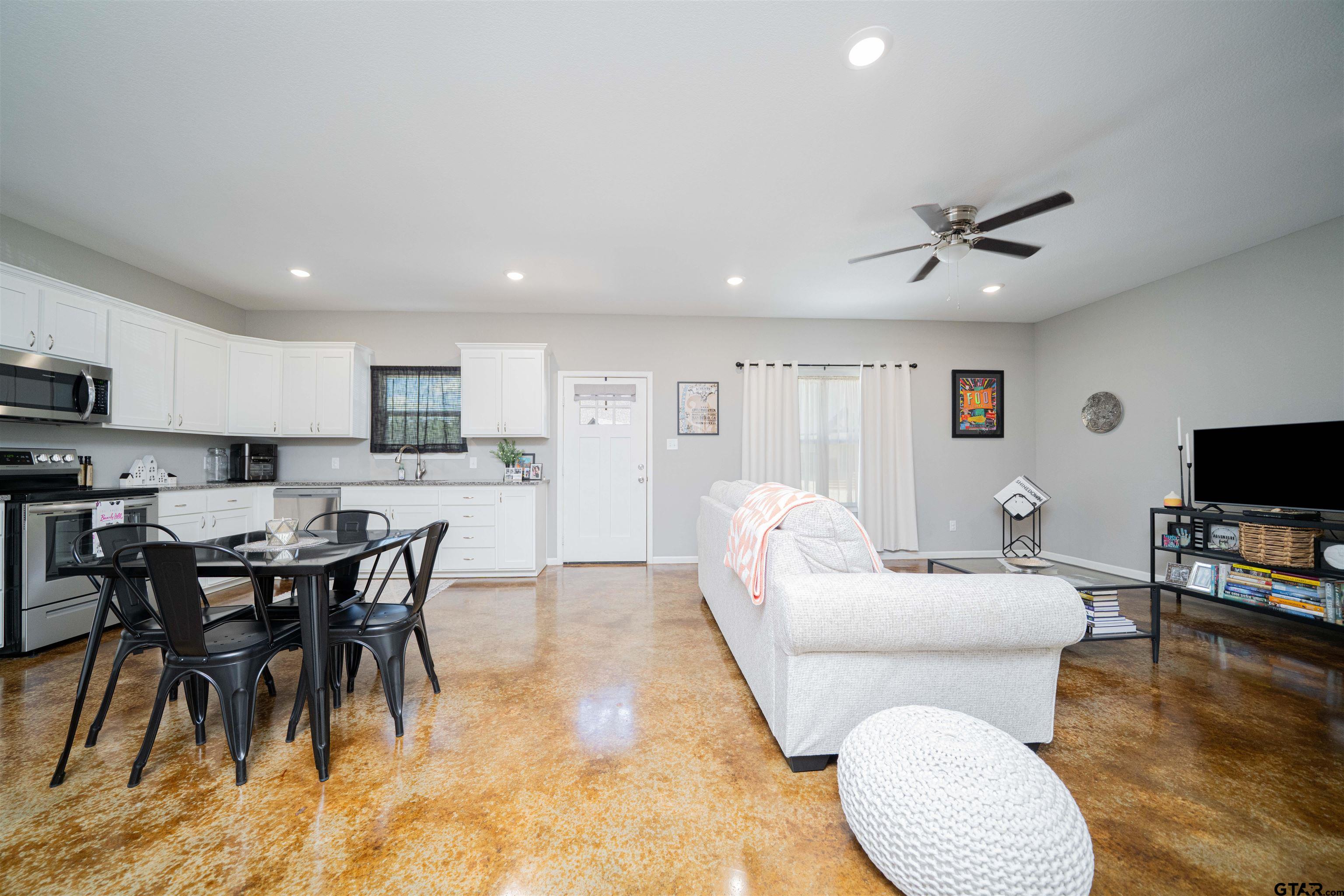 128 Loye Lane Hawkins, TX 75765 - Photo 14 of 25 a living room with furniture a flat screen tv and kitchen view