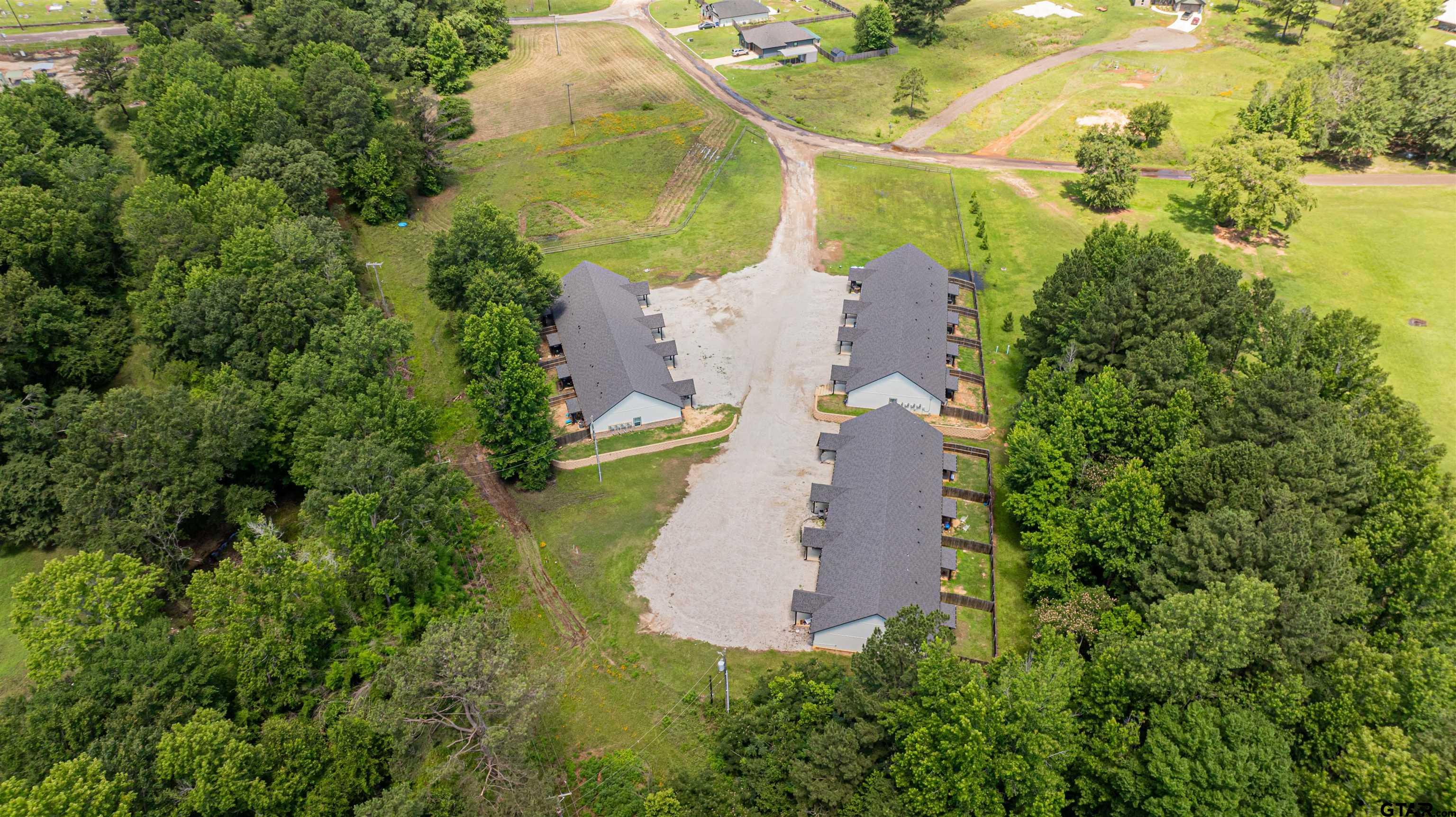 128 Loye Lane Hawkins, TX 75765 - Photo 24 of 25 an aerial view of a house with a yard and large trees