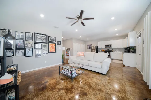 a living room with furniture and kitchen view