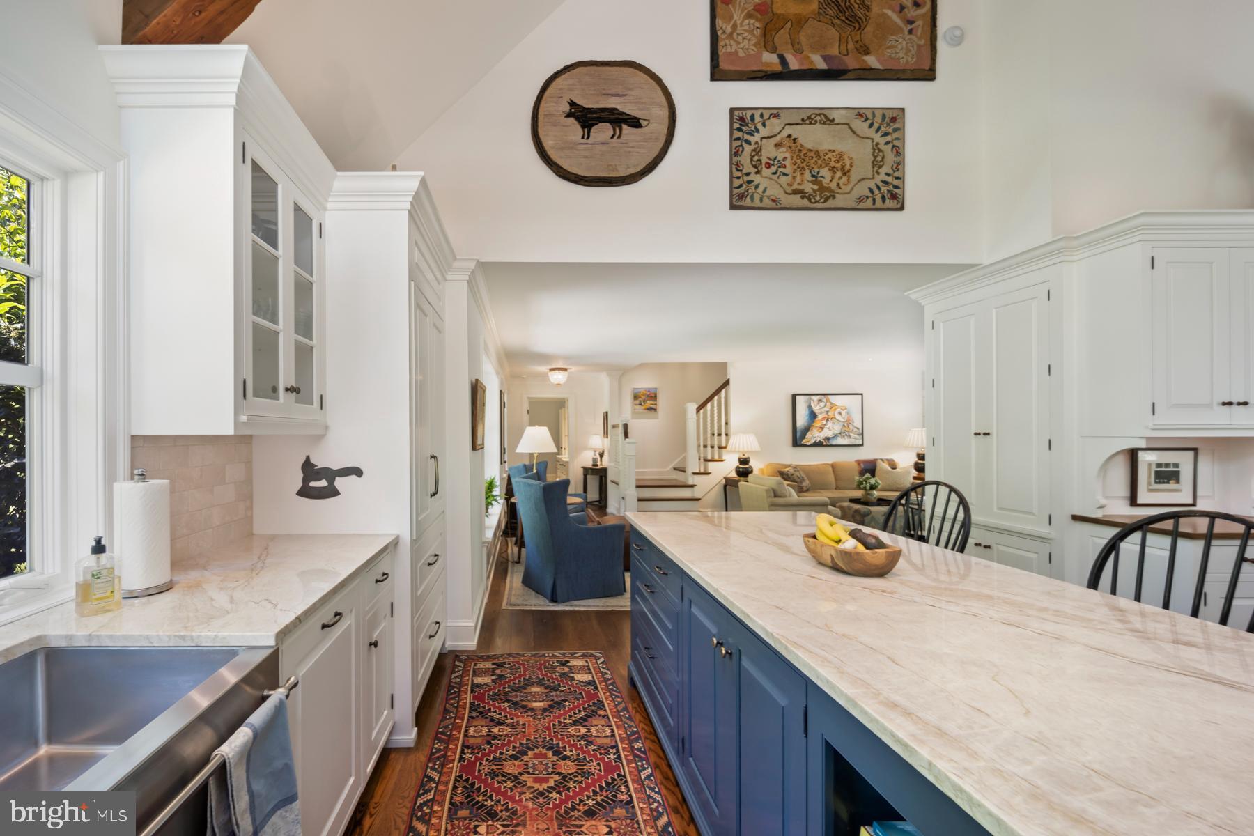 1660 Mt Pleasant Road Villanova, PA 19085 - Photo 7 of 43 a large kitchen with kitchen island a stove a sink a chimney and a dining table