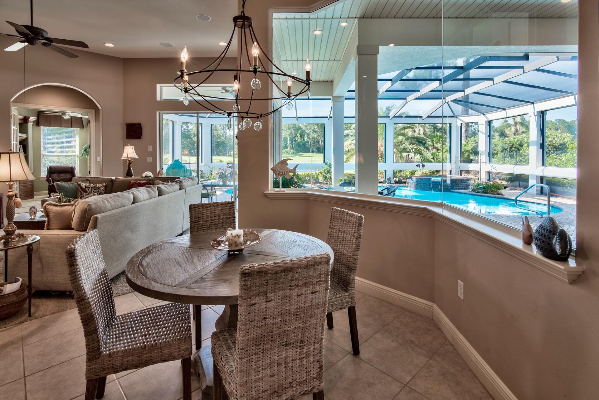 2956 Pine Valley Road Miramar Beach, FL 32550 - Photo 15 of 69 a dining room with furniture a chandelier and wooden floor
