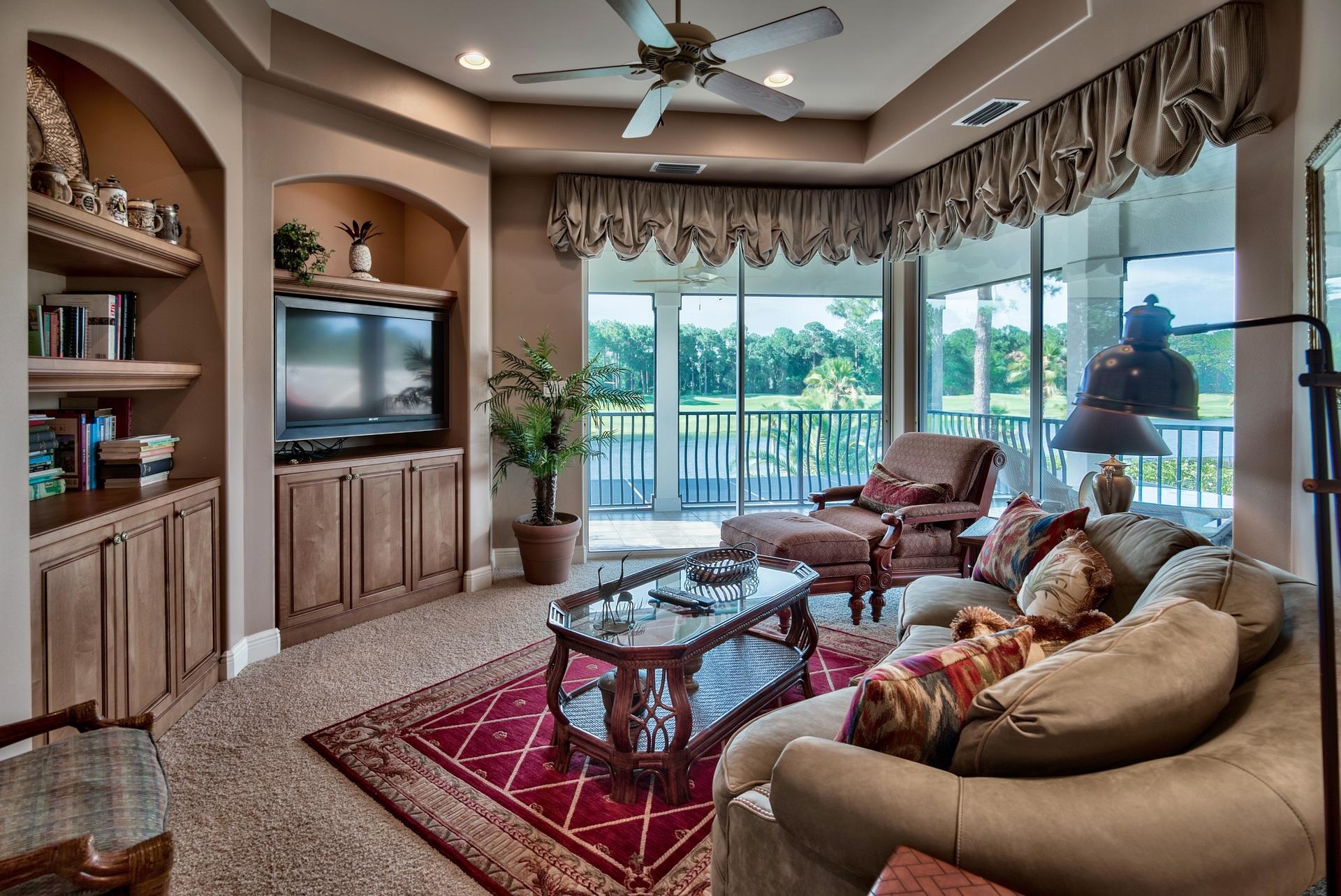 2956 Pine Valley Road Miramar Beach, FL 32550 - Photo 39 of 69 a living room with furniture a flat screen tv and a floor to ceiling window