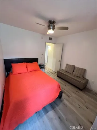 a bedroom with a bed and wooden floor