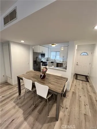 a large kitchen with a table and chairs in it