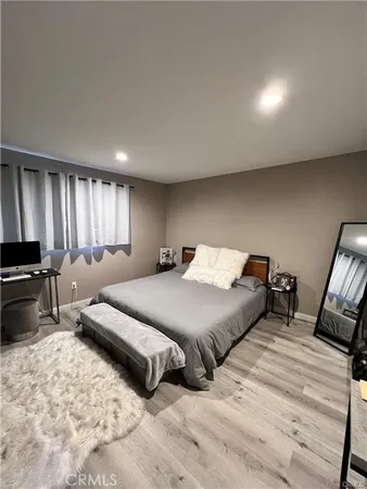a spacious bedroom with a bed and a couch