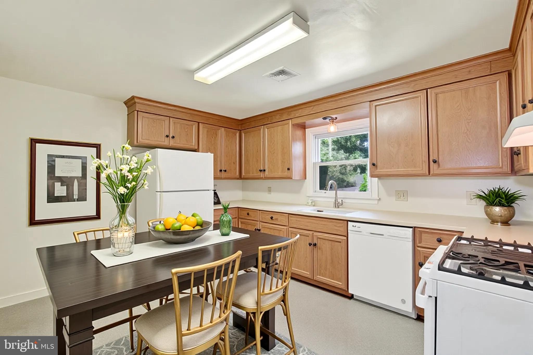 823 Glendale Road York, PA 17403 - Photo 11 of 33 a kitchen with a table chairs stove and cabinets
