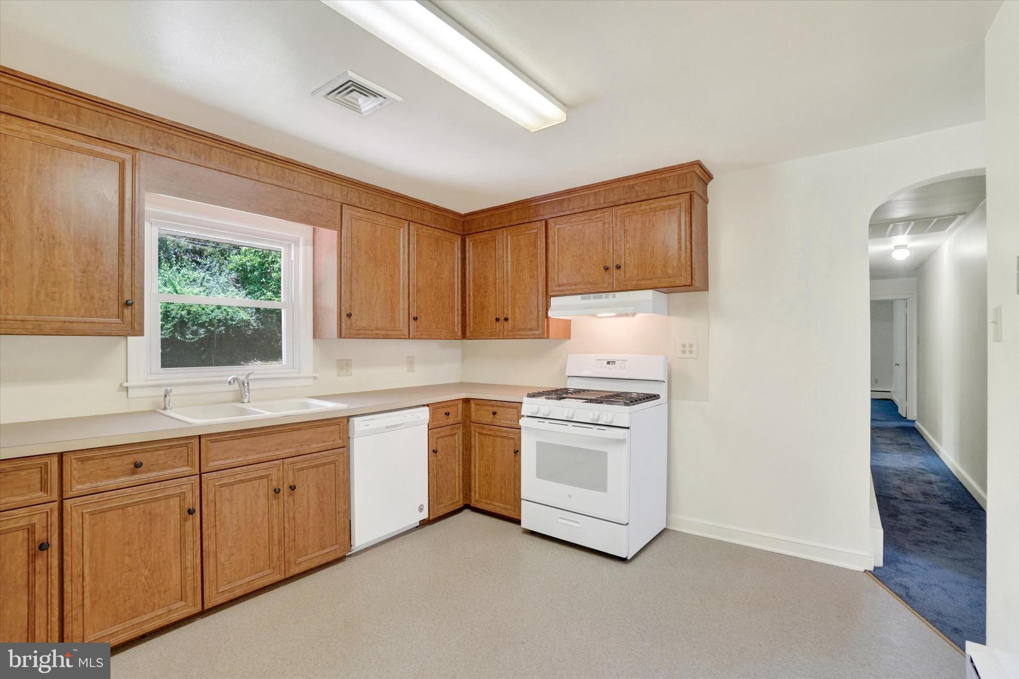 823 Glendale Road York, PA 17403 - Photo 13 of 33 a kitchen with white cabinets and white appliances