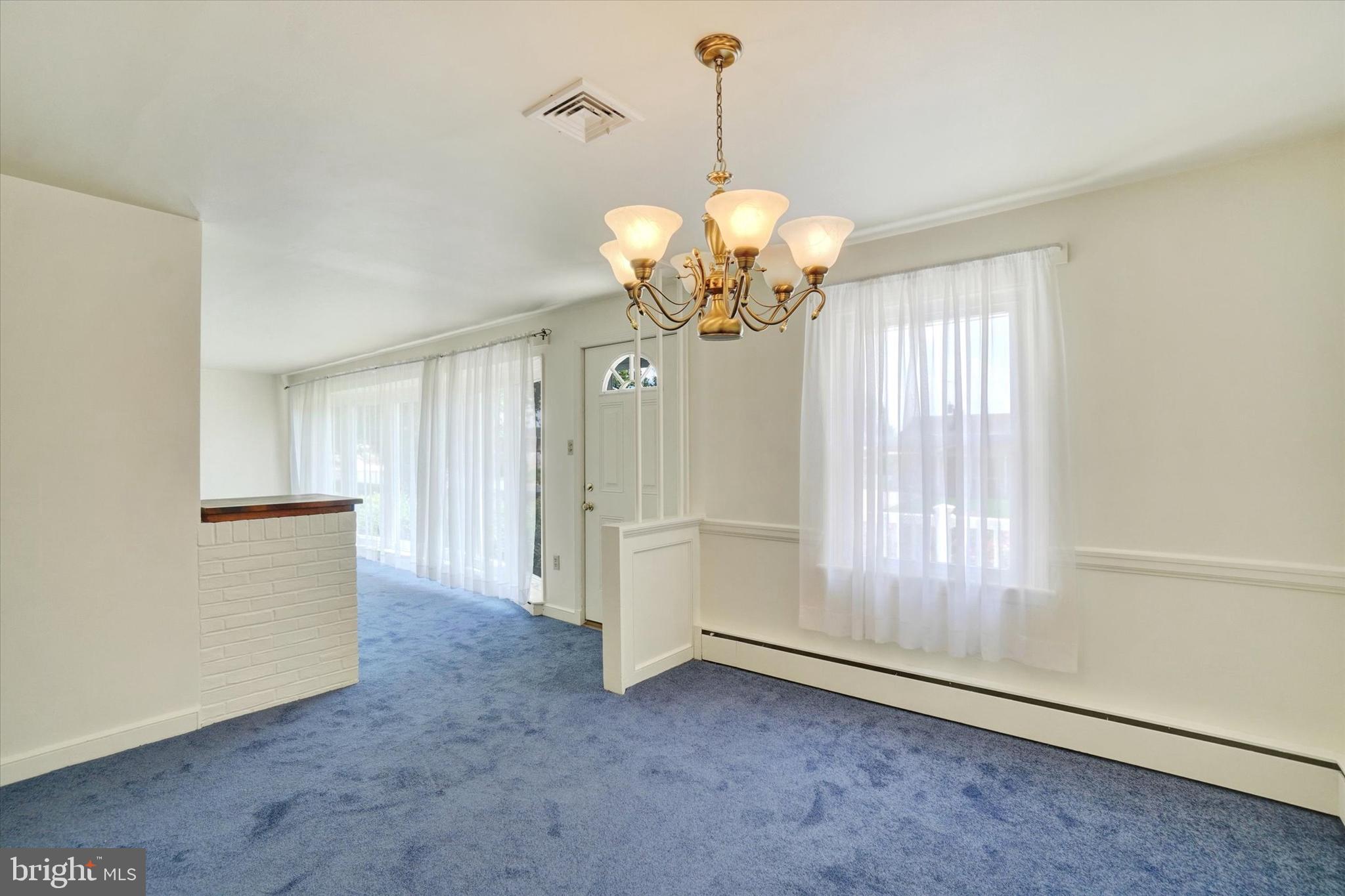 823 Glendale Road York, PA 17403 - Photo 10 of 33 a view of a big room with chandelier fan and windows