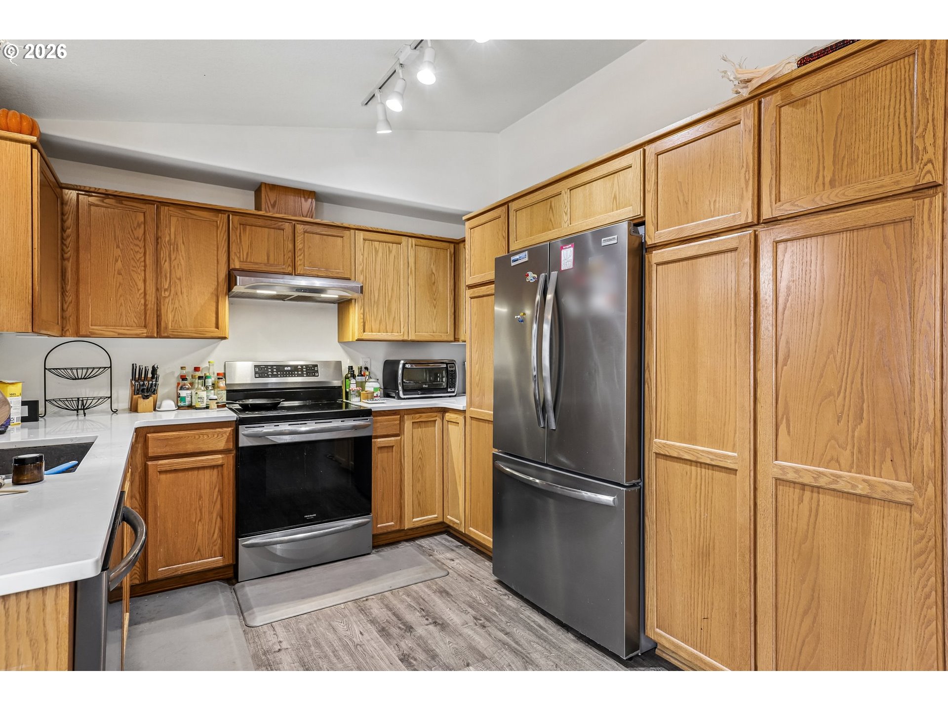 608 Southeast Sumner Street Camas, WA 98607 - Photo 11 of 39 a kitchen with granite countertop a refrigerator and a sink