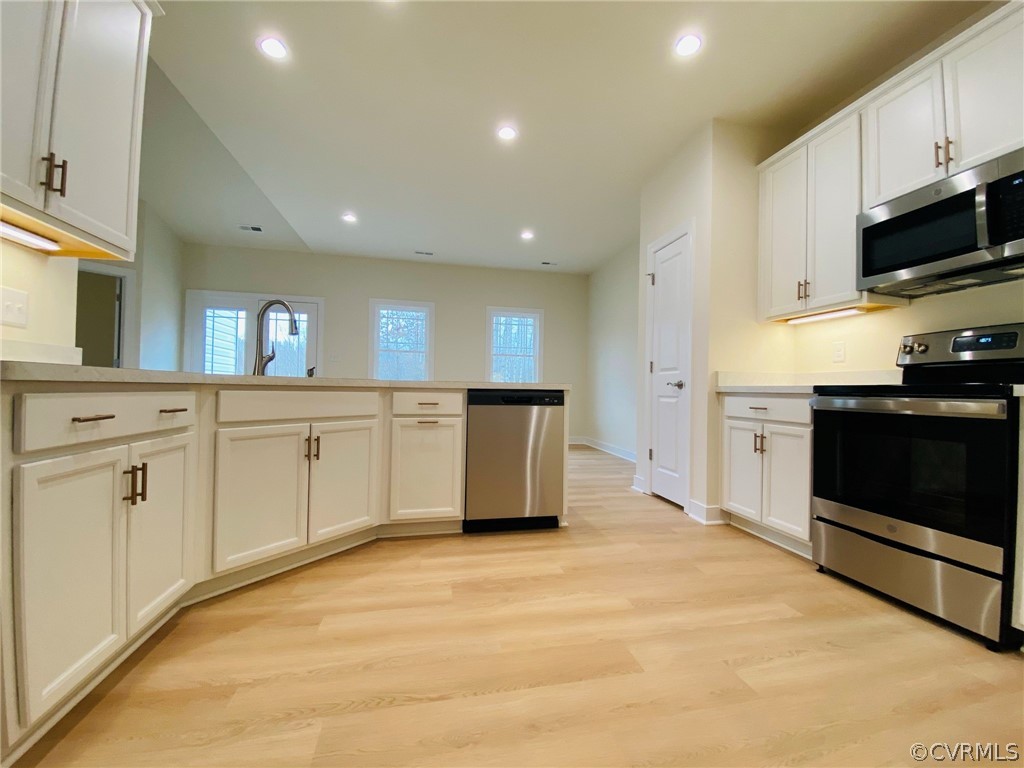 445 New S Ridge Road Bumpass, VA 23024 - Photo 8 of 38 a large kitchen with stainless steel appliances granite countertop a stove a sink and a microwave