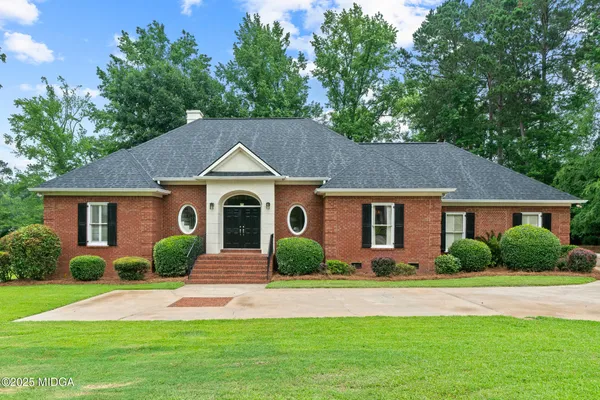 a front view of a house with garden