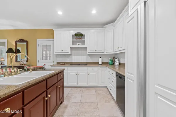 a large kitchen with kitchen island granite countertop a sink and stainless steel appliances