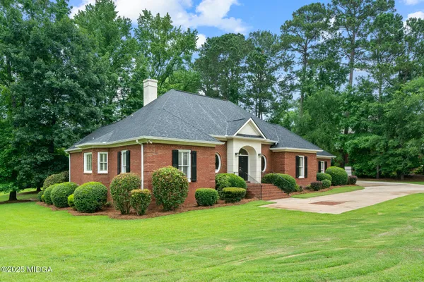 a house that has a tree in front of it
