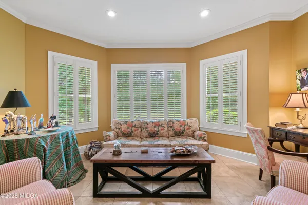 a bedroom with a large bed and a dresser next to a window