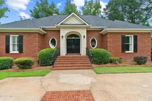 a front view of a house with garden