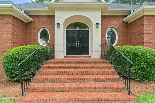 a view of staircase with white walls and a window