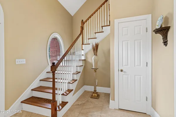 a living room with furniture fireplace and a large window