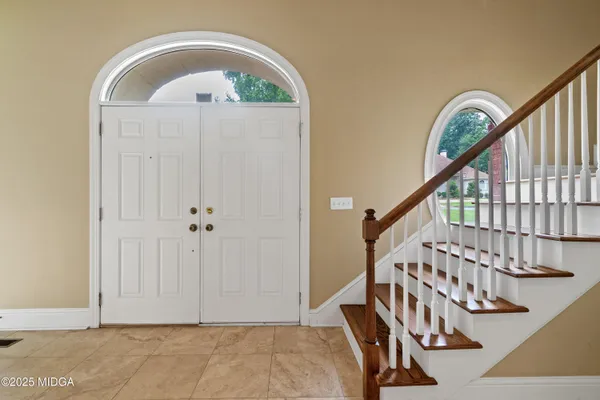 a living room with furniture and a piano